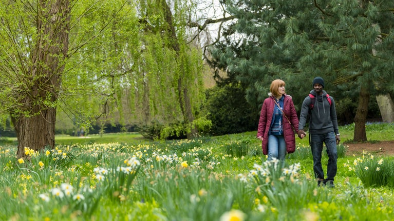 Visitors walking in the garden in spring at Belton Estate, Lincolnshire